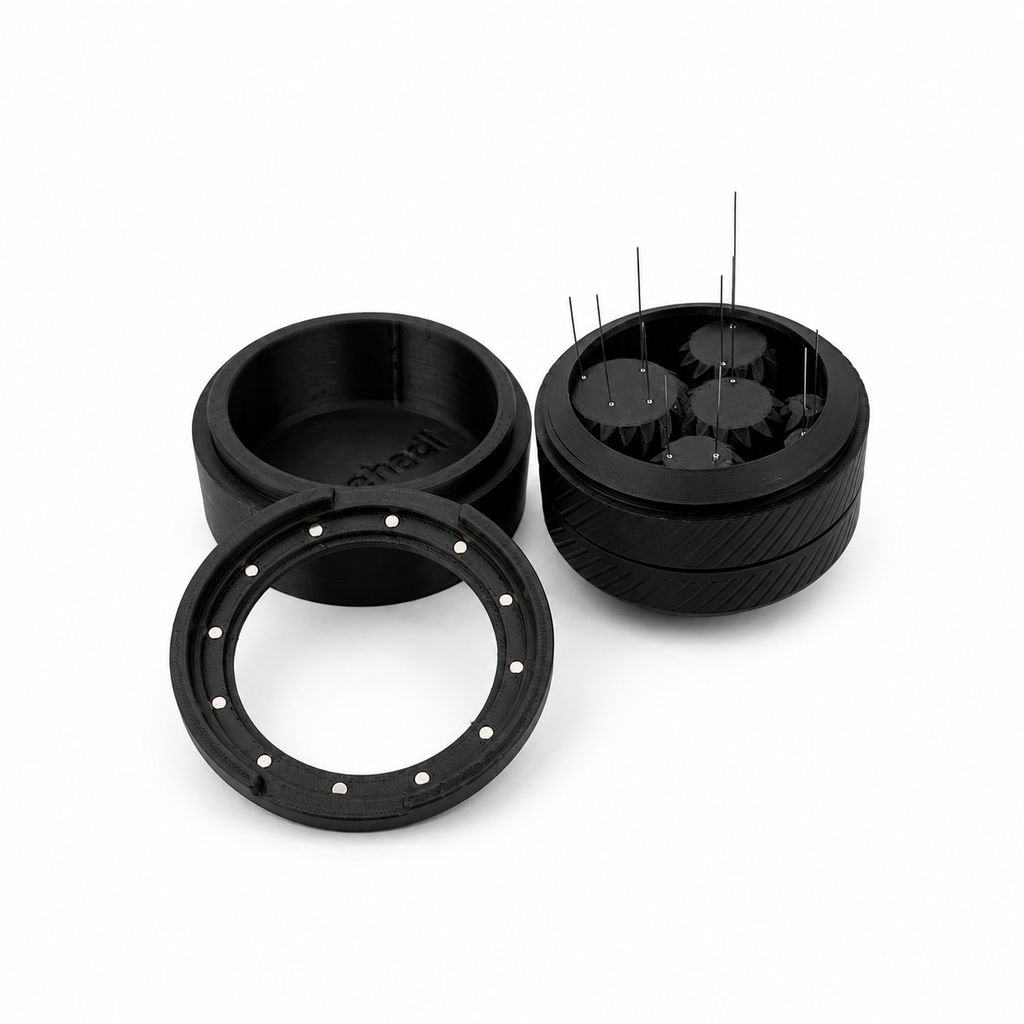 Spirobutor 1000 disassembled into base, magnetic spin ring and needle mech