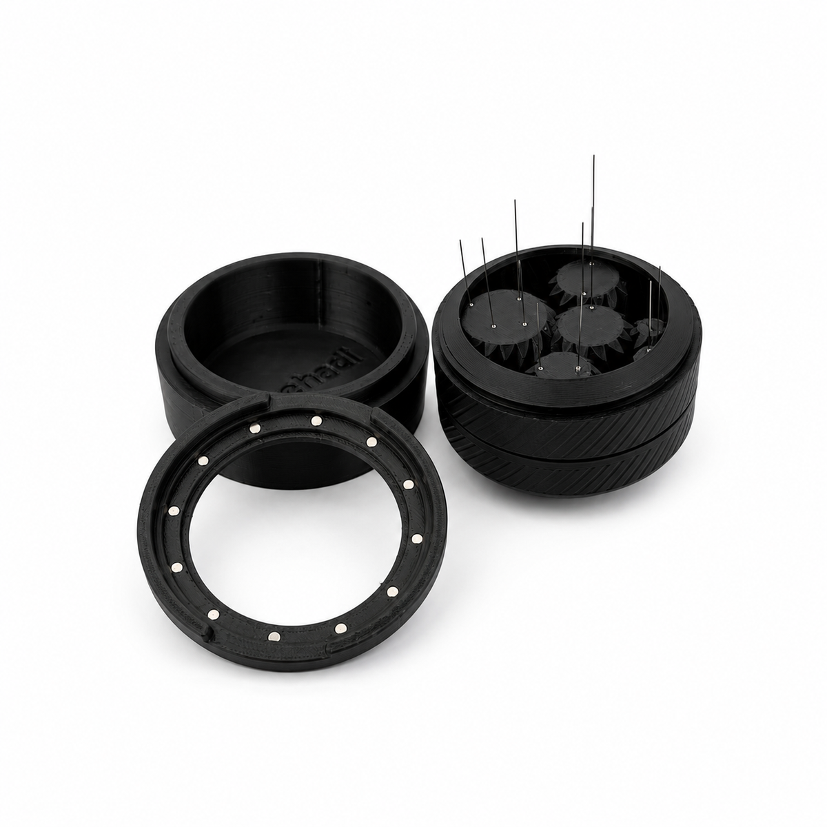 Spirobutor 1000 disassembled into base, magnetic spin ring and needle mech